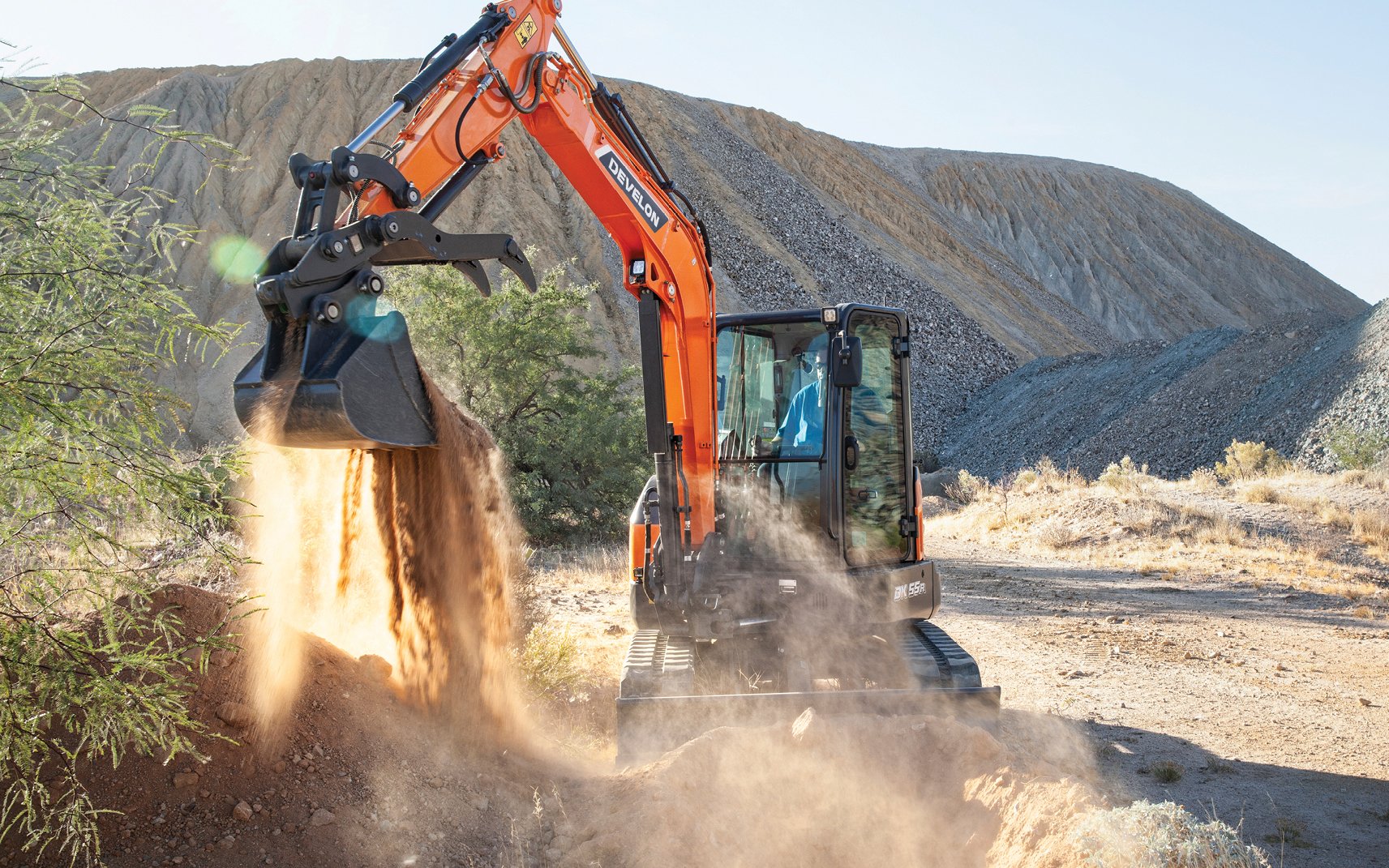  A DEVELON mini excavator digs on a job site.