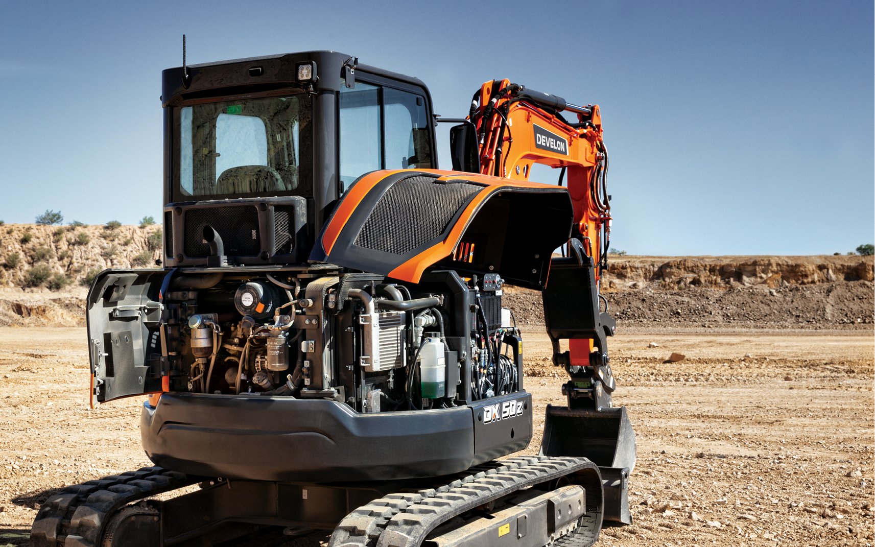 A DX50Z-7 mini excavator with panels open for inspecting internal components.