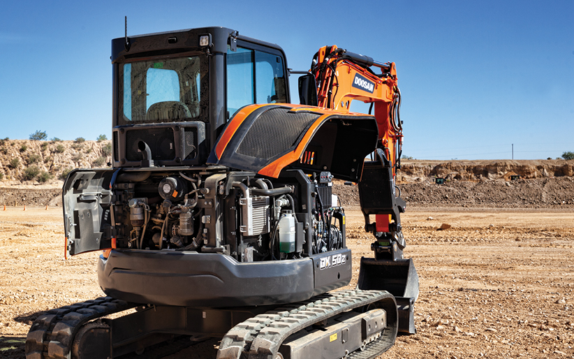The swing-open tailgate and side-access hood open on a DX50Z-7 Doosan mini excavator.