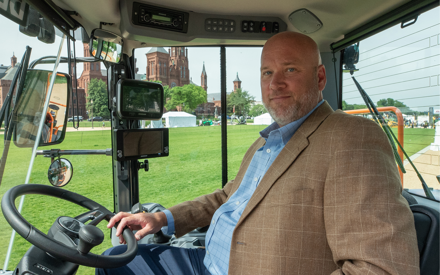 Todd Roecker, vice president of initiatives, sits in a DEVELON wheel loader. 