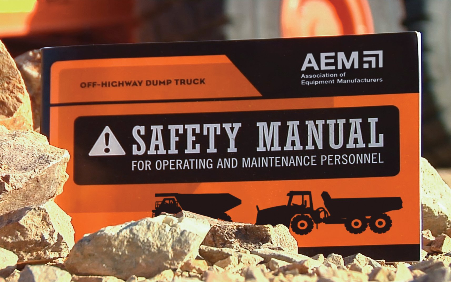 An AEM safety manual for operating and maintaining an off-highway dump truck.