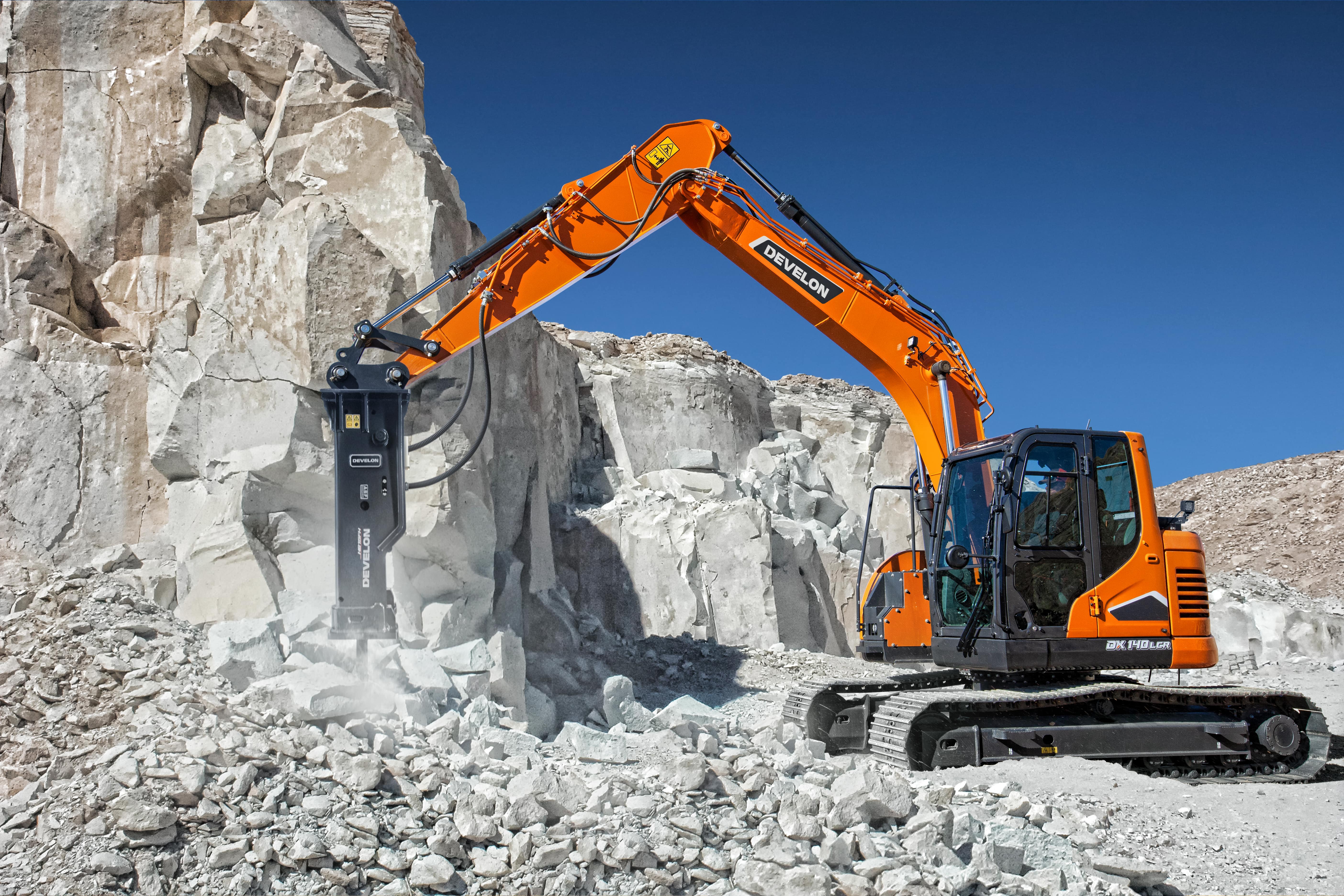 A DEVELON HB-Series hydraulic breaker on a DX140LCR-7 crawler excavator breaking concrete.