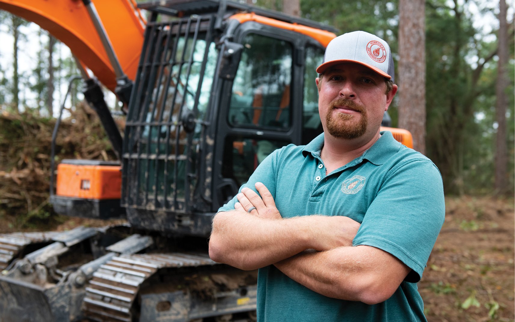 Gabriel Shemper, Homestead Services, LLC, in front of his DEVELON equipment.