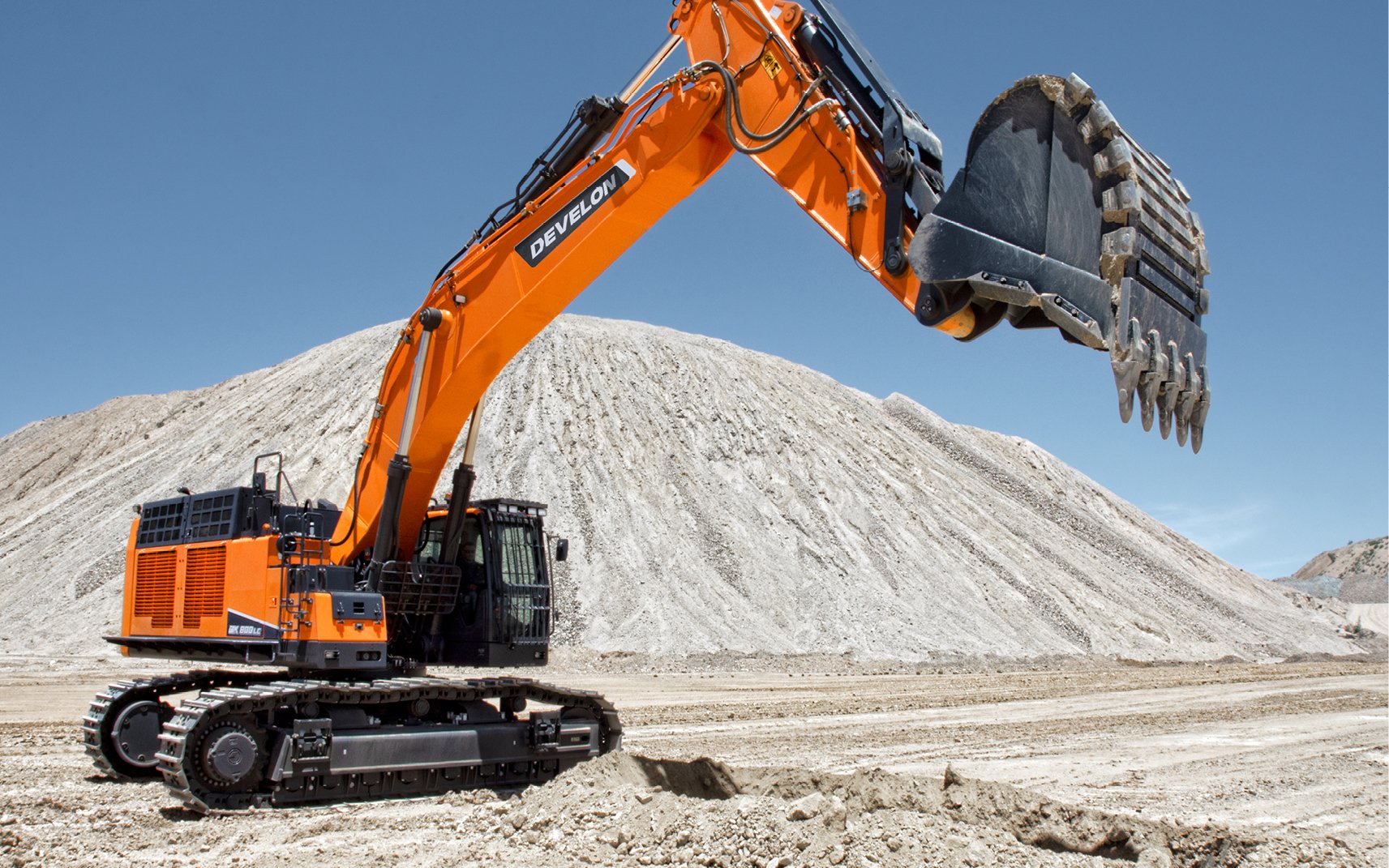 A DX800LC-7 crawler excavator getting ready to scoop with a bucket attachment.