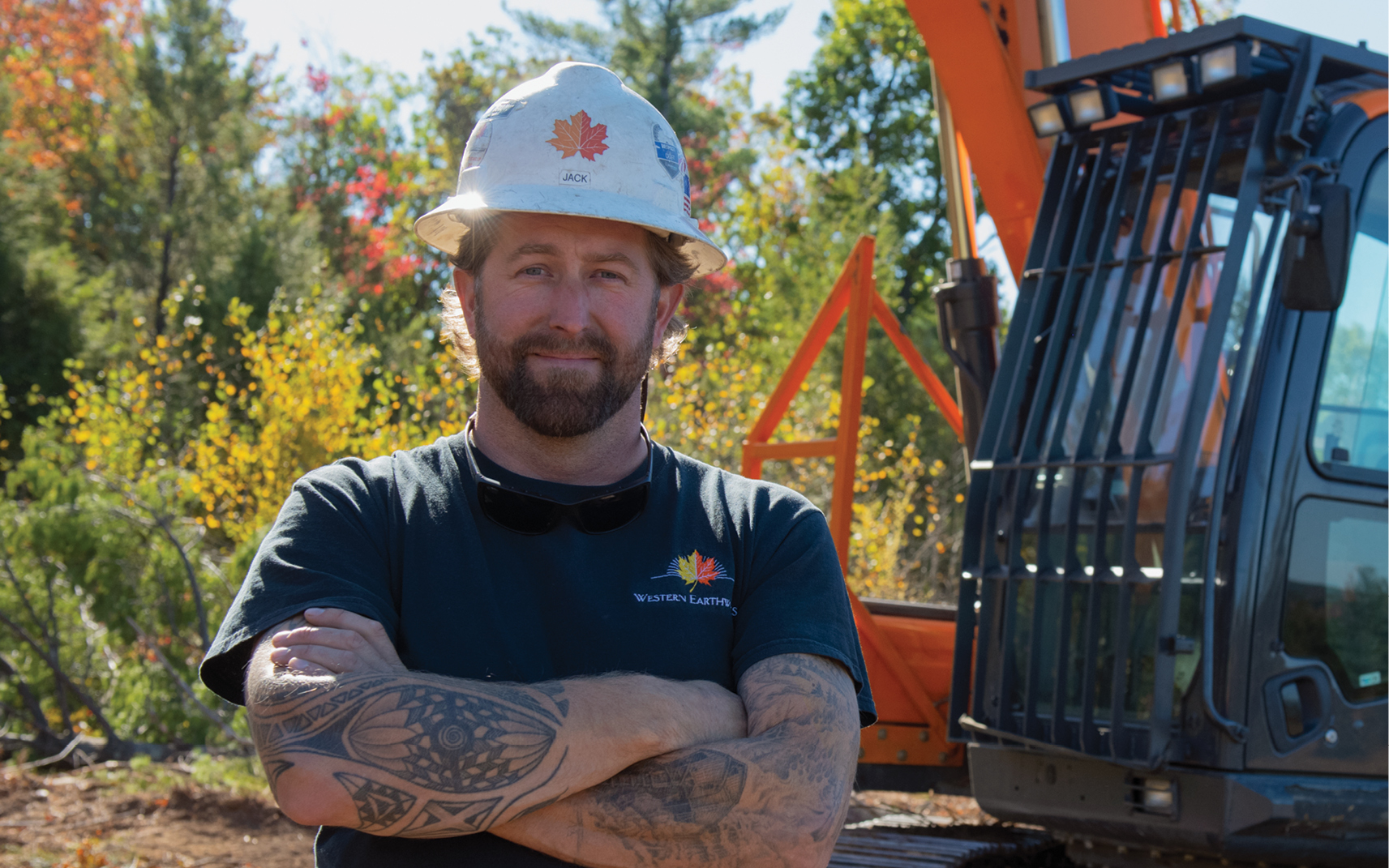 Jack Henderson-Adams, Western Earthworks, in front of his DEVELON equipment.