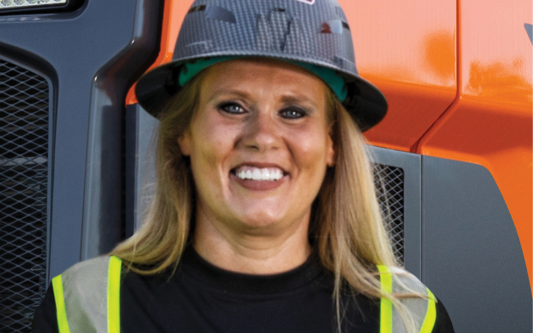 Melissa Britt, Britt Demolition & Recycling, standing in front of DEVELON equipment.