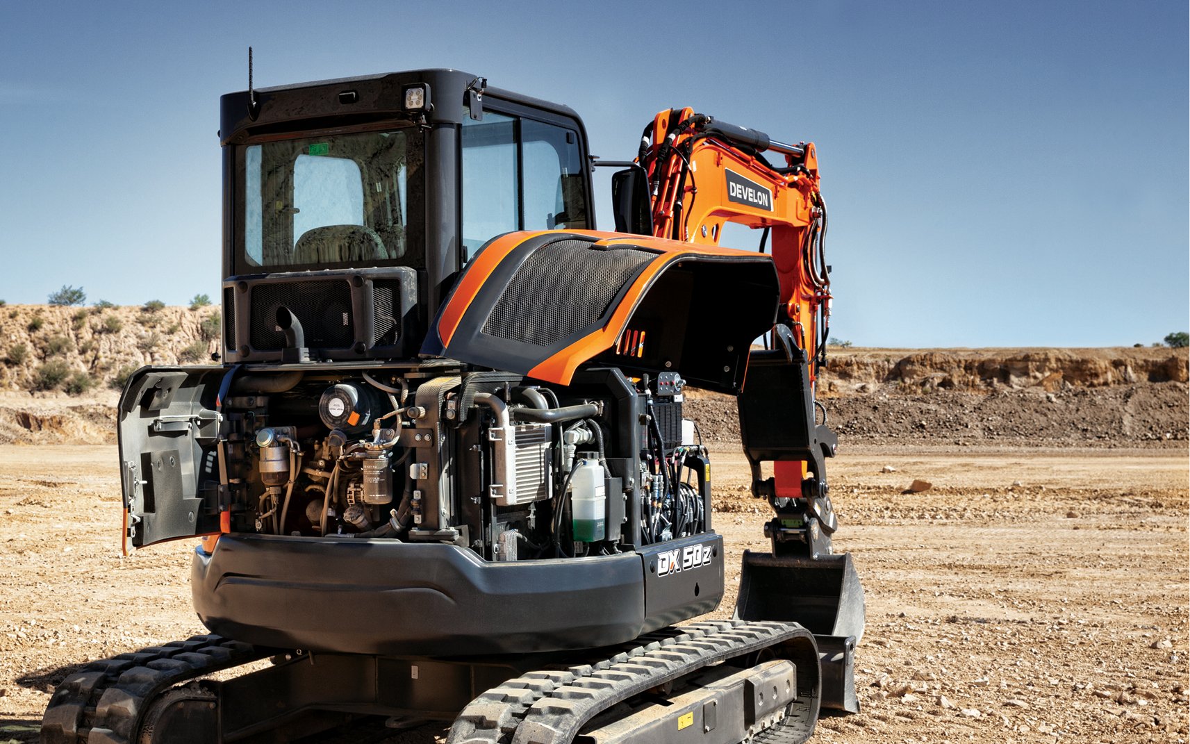 A DEVELON mini excavator with open machine panels for easy servicing